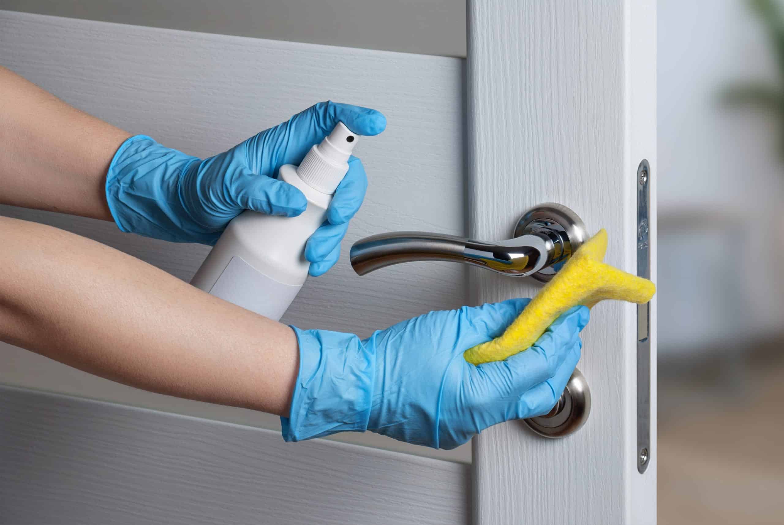 a person cleaning door handle