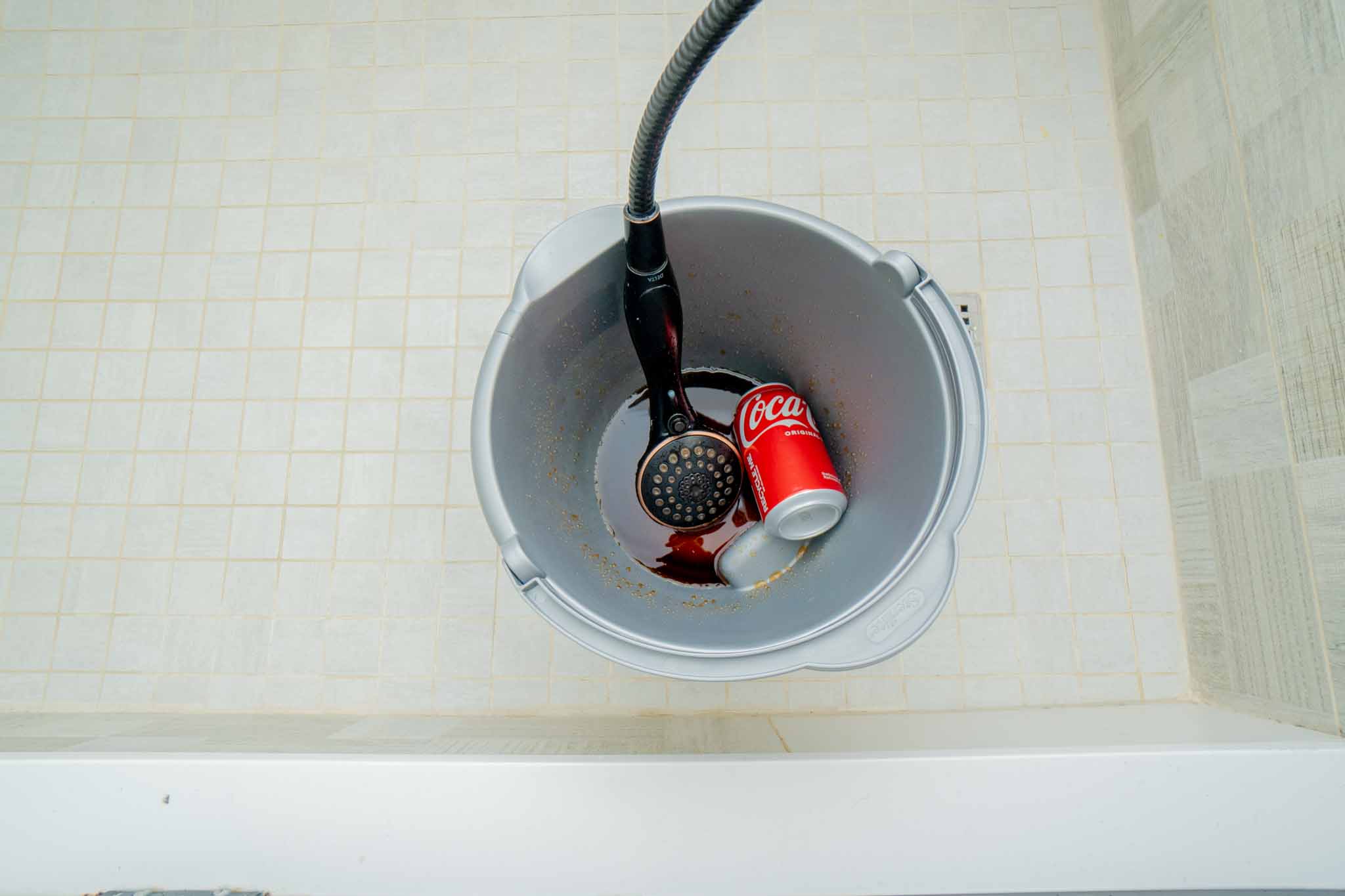 Pouring coco cola on shower head