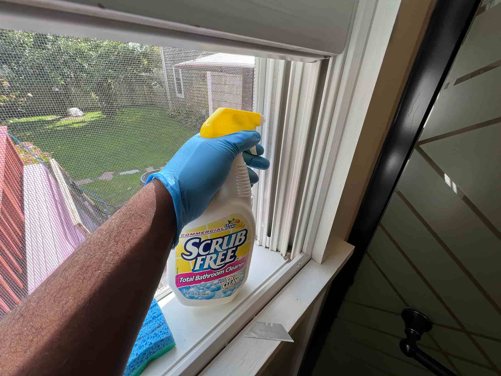 spraying window track with bleach