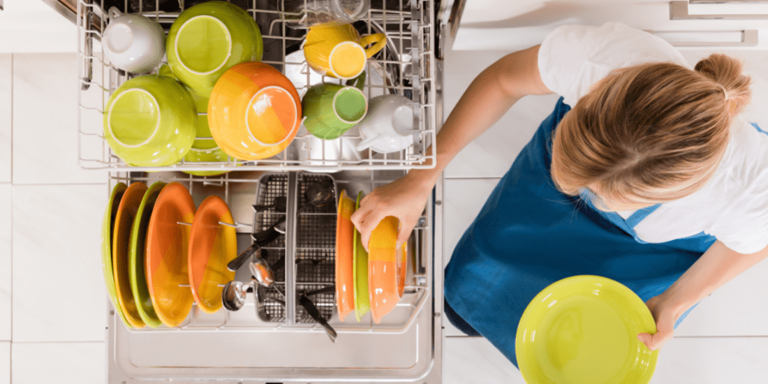 woman putting things in the dishwasher