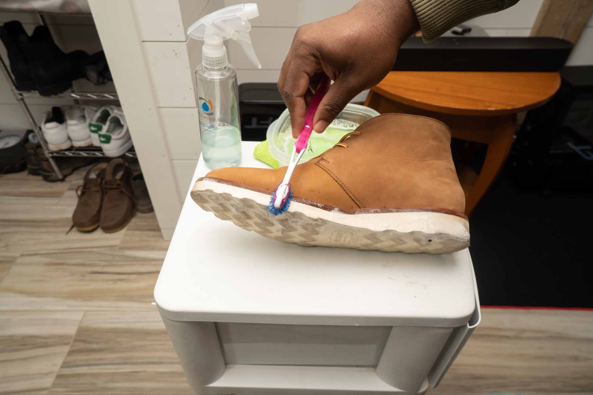cleaning leather boot sole with toothbrush and dawn dish soap