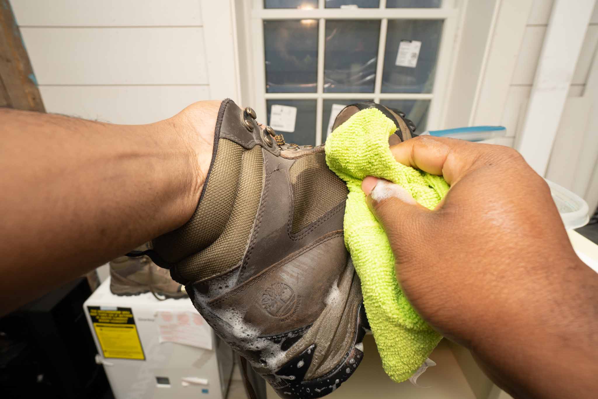 wiping down work boots with microfiber cloth