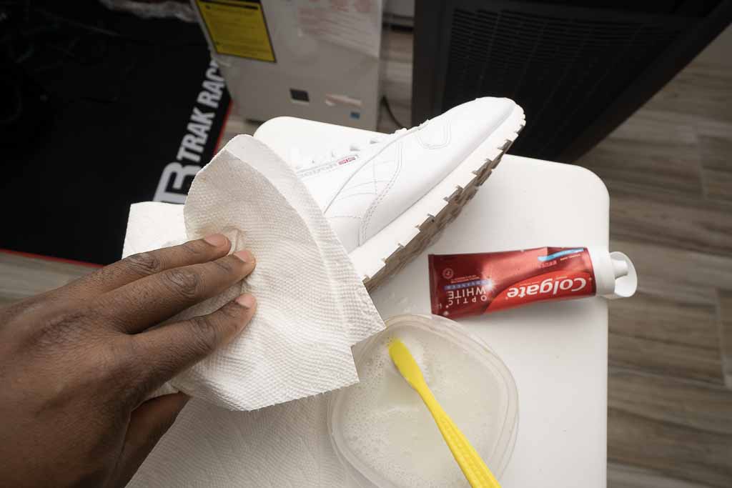 using paper towel to clean white shoe