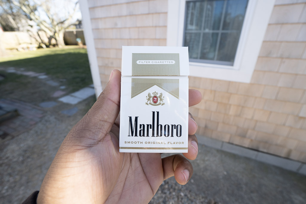 person holding box of cigarettes