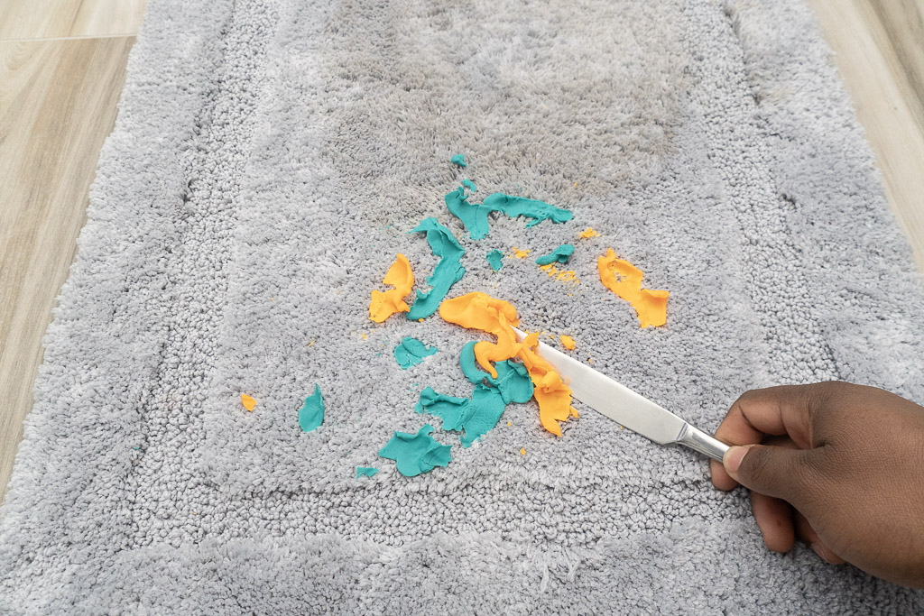 taking playdough off carpet with knife