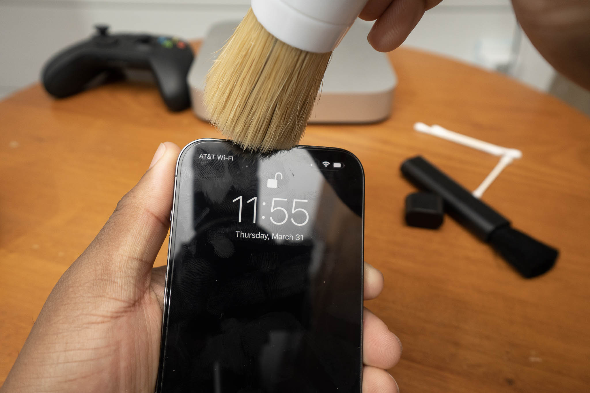 cleaning iphone earpiece speaker with detail brush