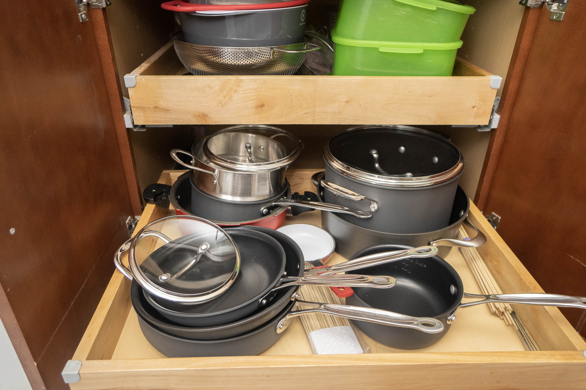 pots and pans in cabinet drawer