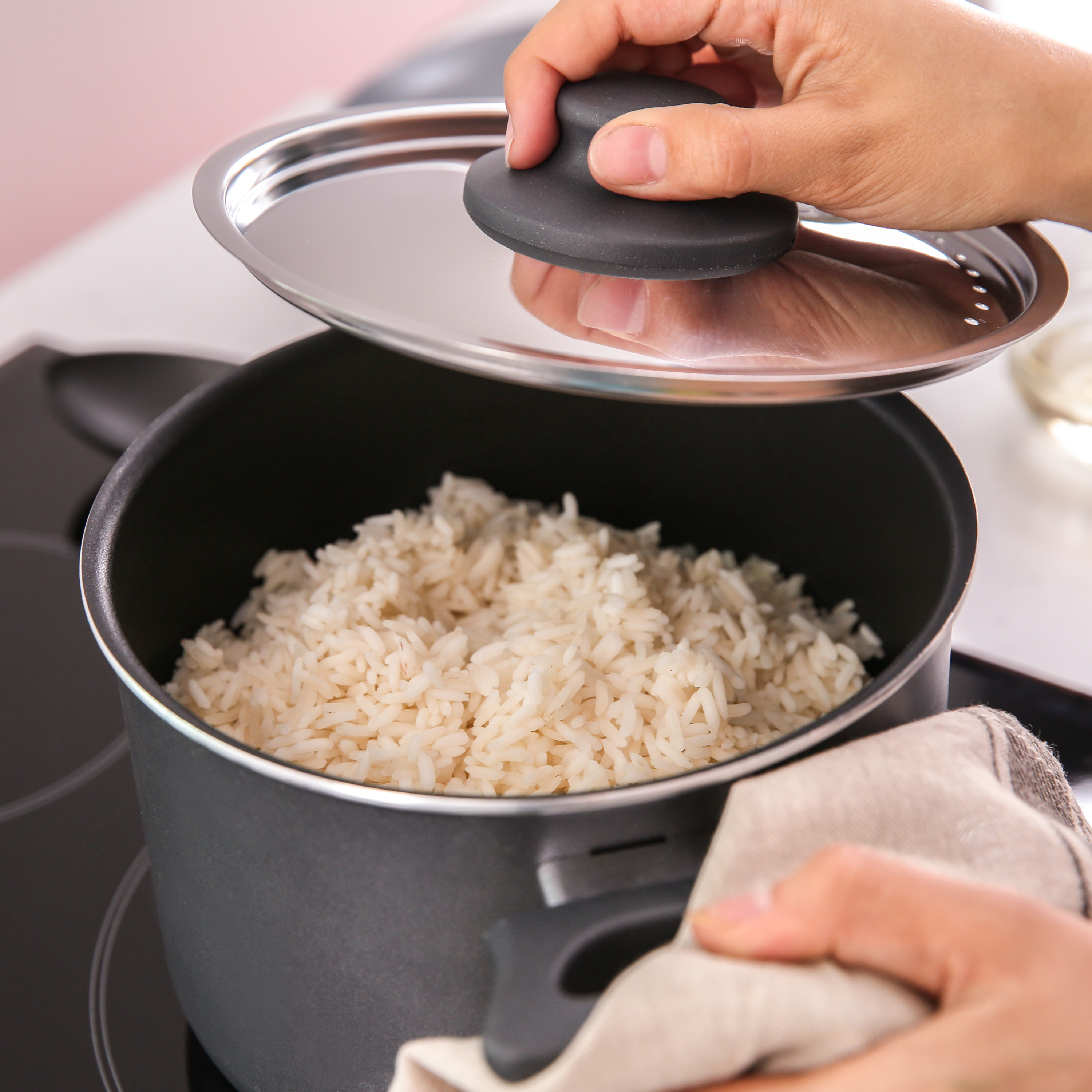 rice cooking in pot with cover open