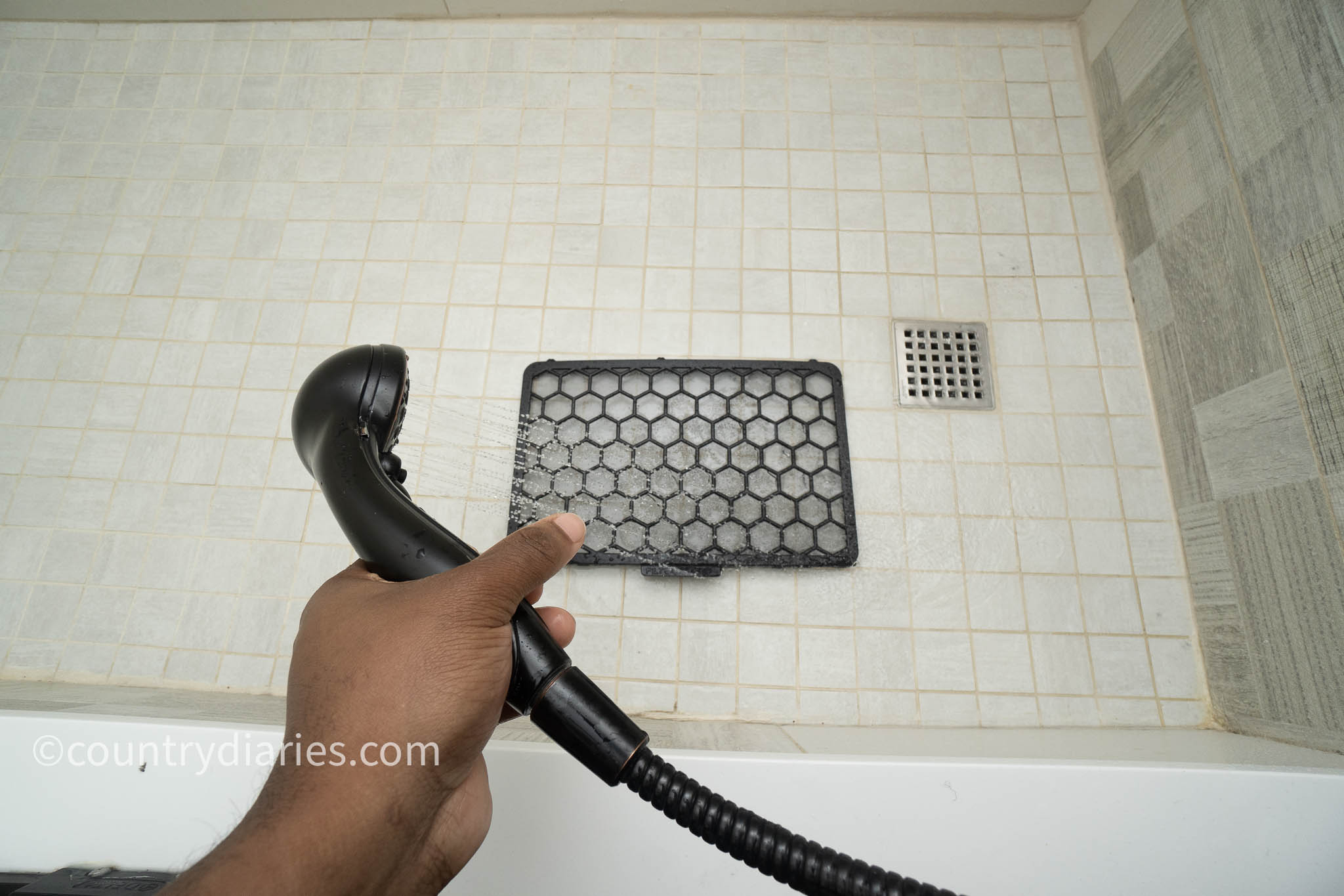 washing dehumidifier filter with shower head