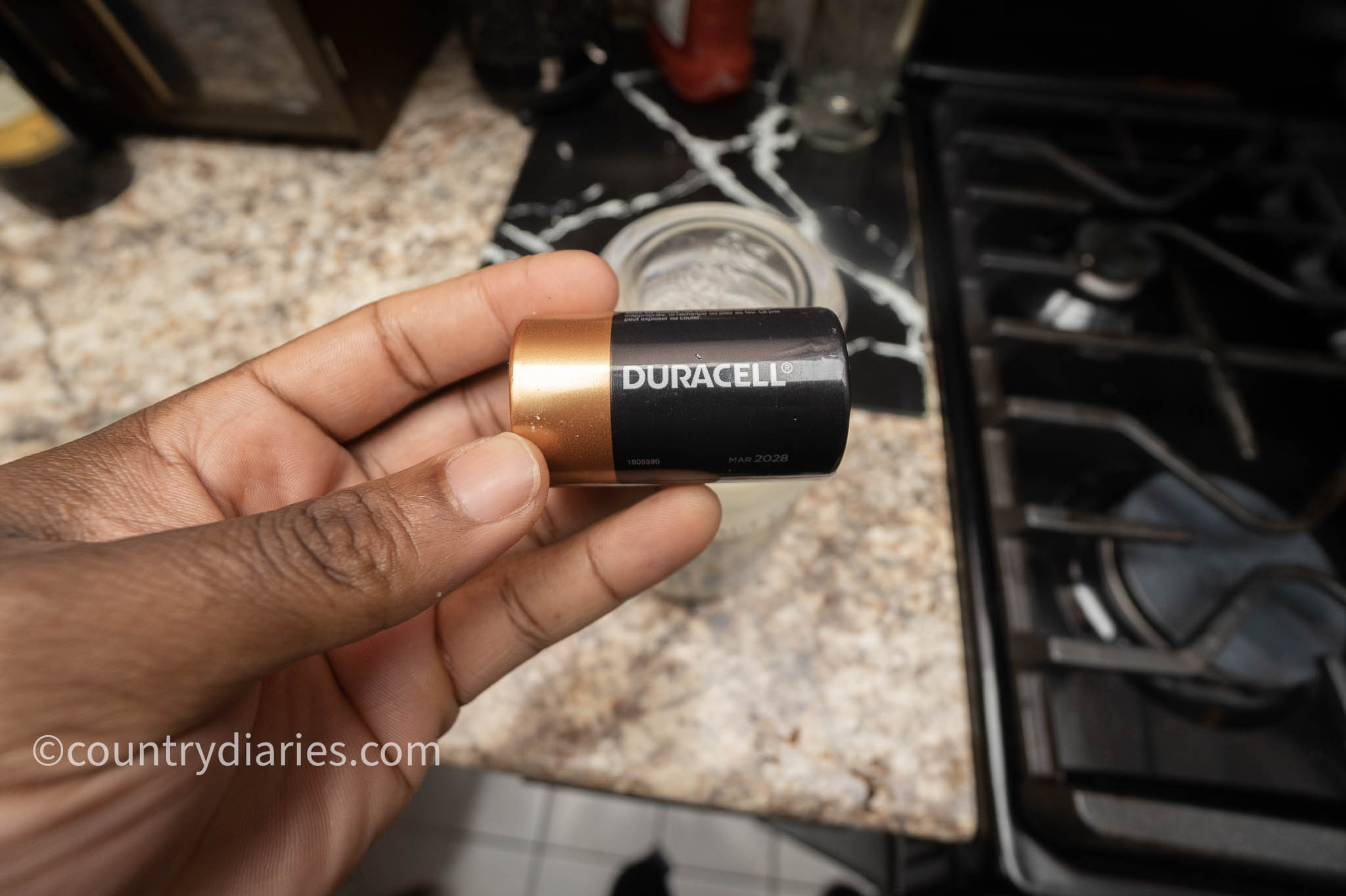 person holding duracell battery