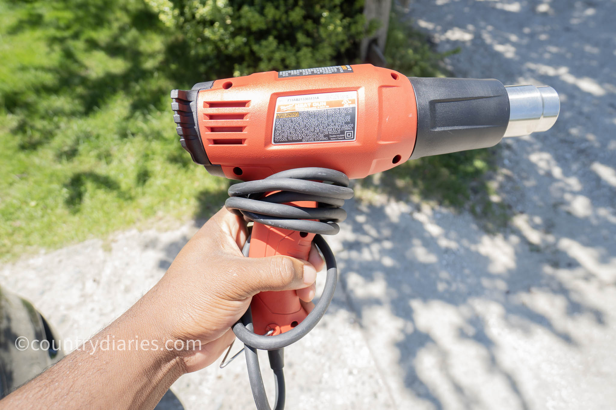 person holding a heat gun